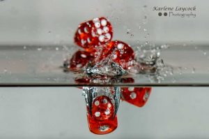 Red Dice falling into water inverted 1