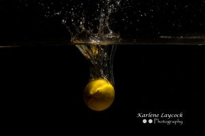 Lemon dropping into water on black background 1