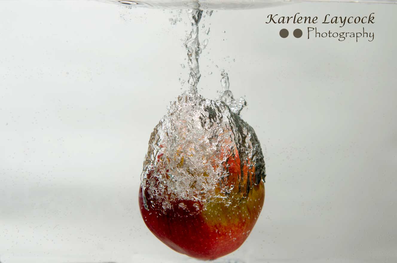 Red Apple encased in water bubble on grey 3