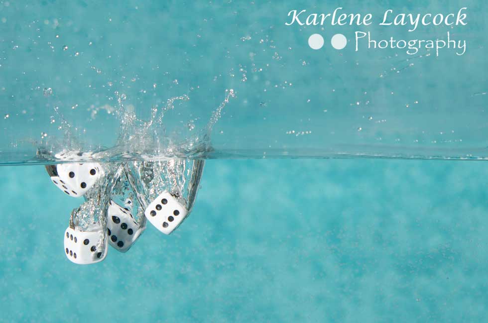 White Dice falling in to water on blue series 3