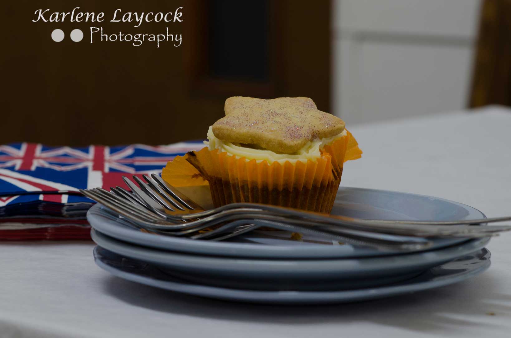 Bake Off Cupcake topped with a Star Biscuit on a Saucer with Forks