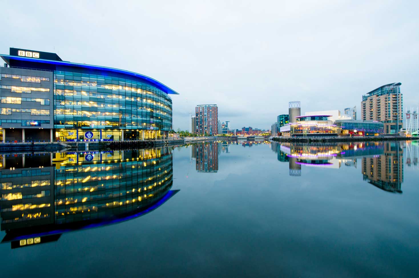 Photograph of Salford Quays Featuring the BBC Building Reflected onto the Quays