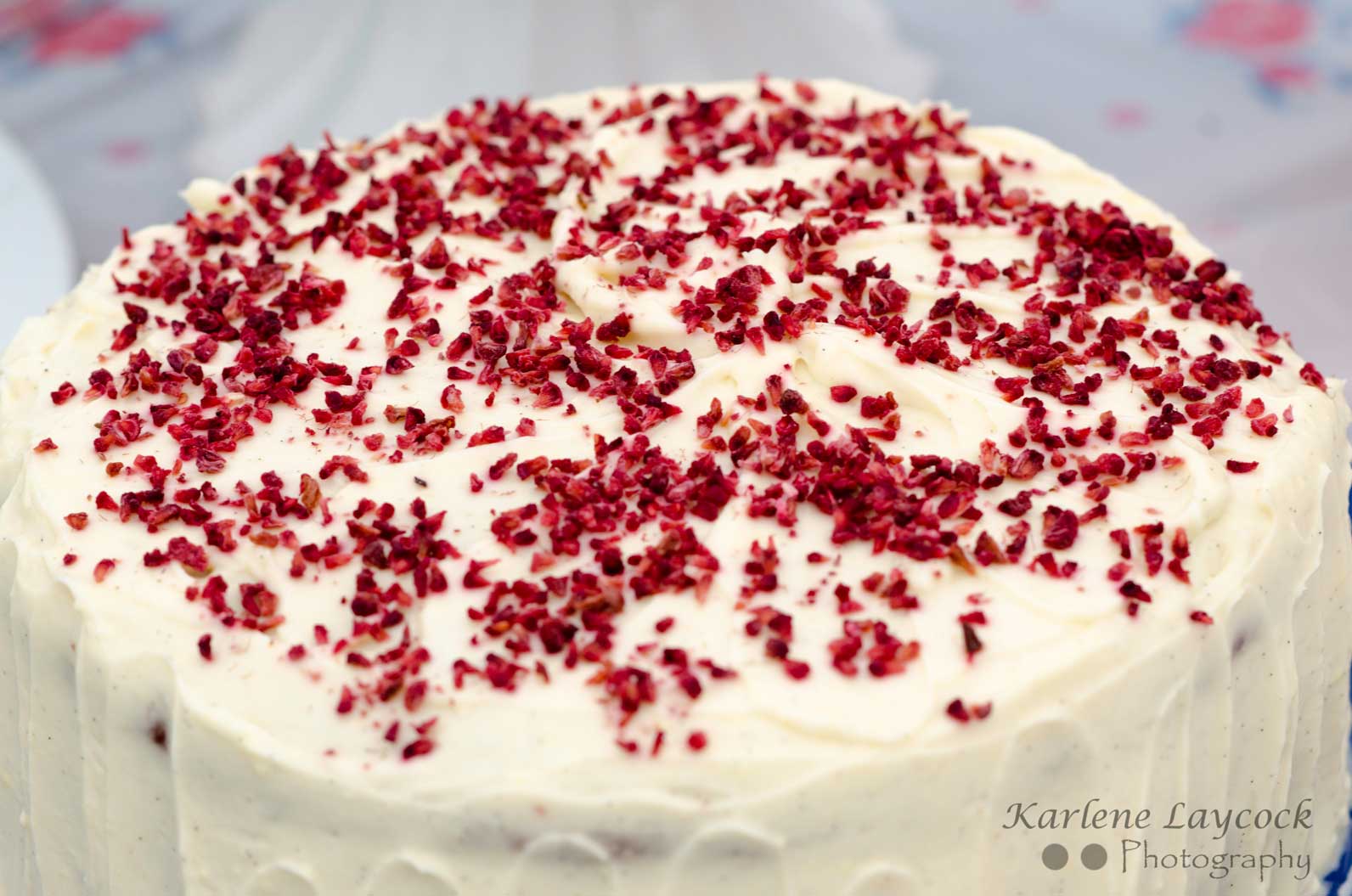 Photograph of a Celebration Cake topped with Red Sprinkles entered into a Local Bake Off Event
